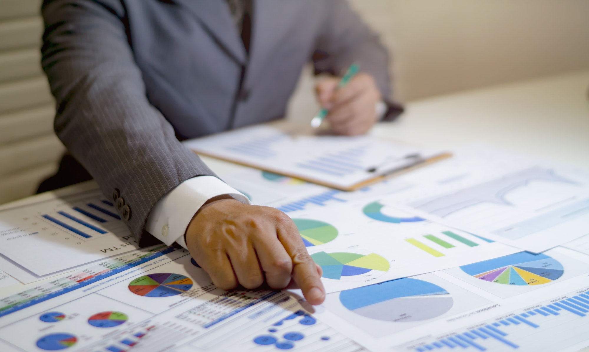 Business people analyzing data on a worksheet